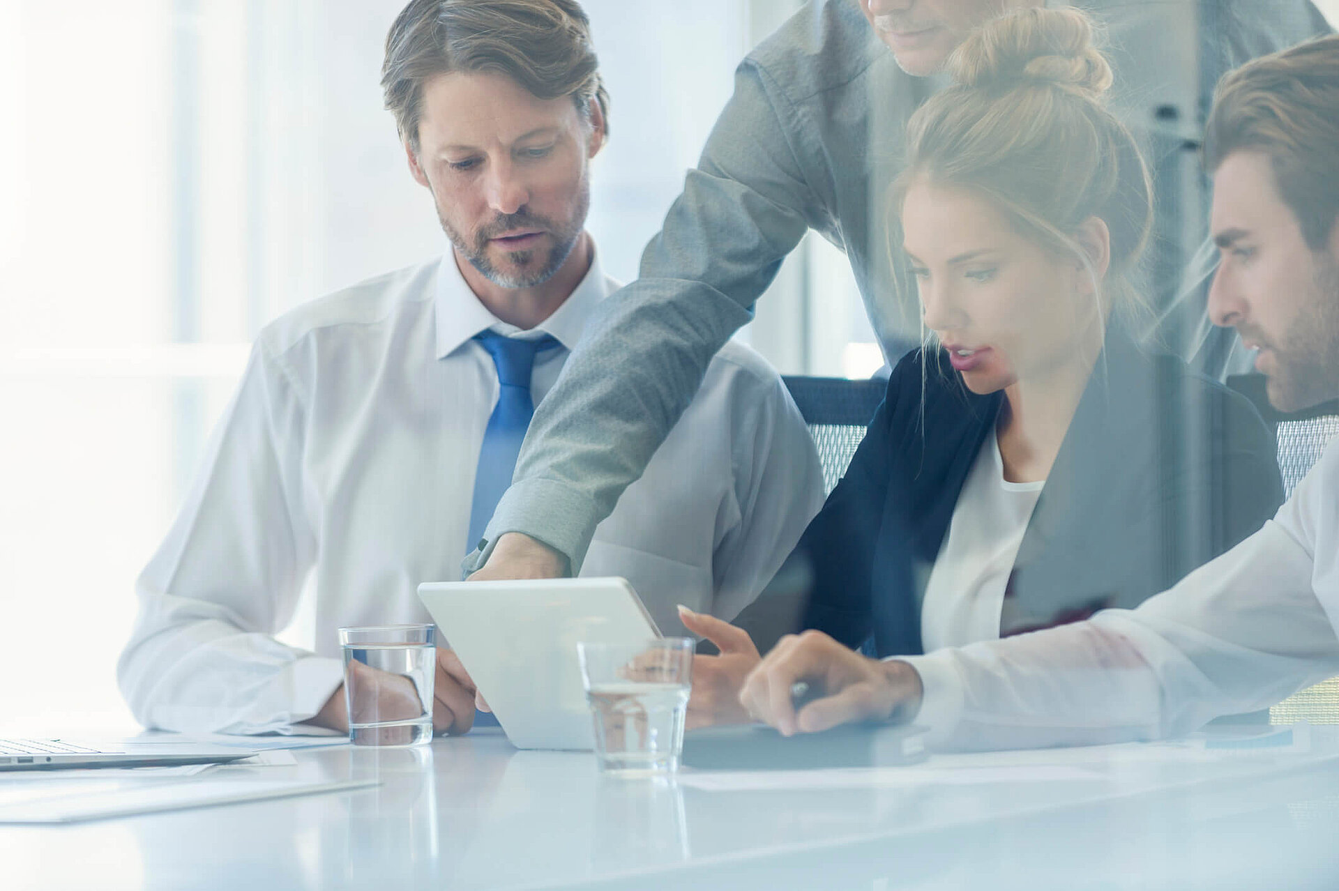 Four business people discussing in the office