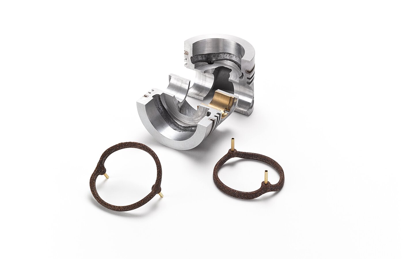 A silver piece of metal and brown salt cores for foundry technology