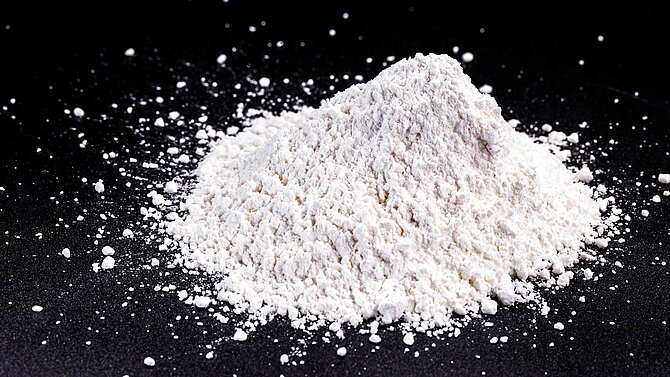White ceramic powder on black background