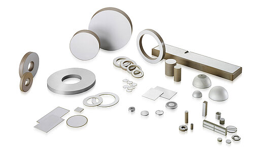 Various products and applications made of piezoceramics on a white background