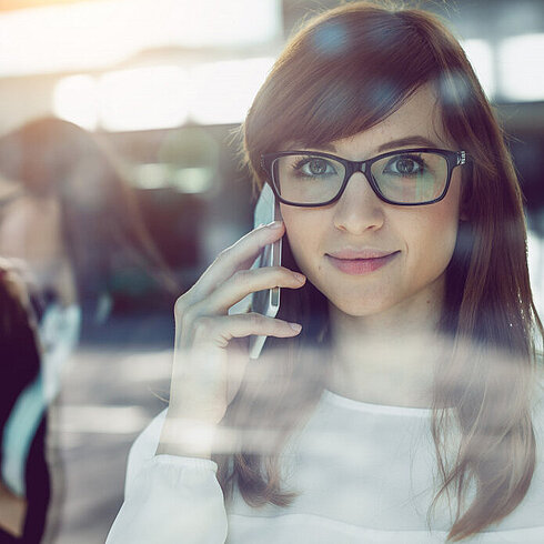 Woman smiling while talking on phone