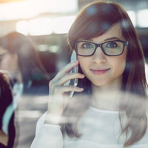 Woman smiling while talking on phone