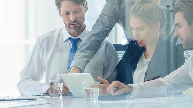 Quatre hommes d'affaires discutent dans un bureau