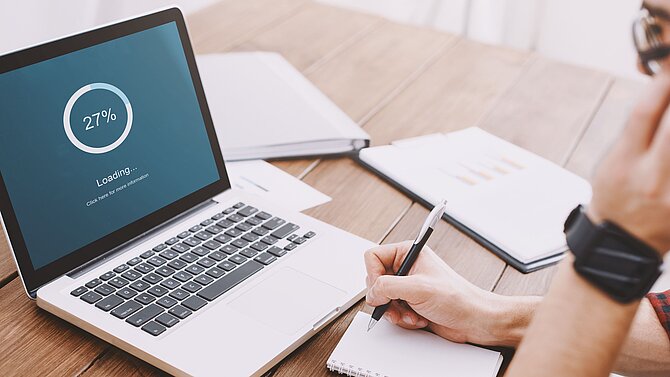 Man looks into screen during download